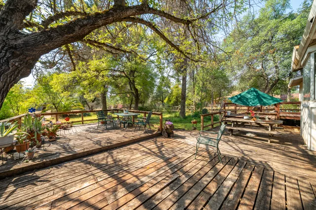 a view of a swimming pool with a patio and a yard