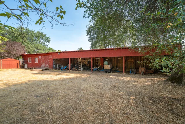a front view of a house with a yard and tree s