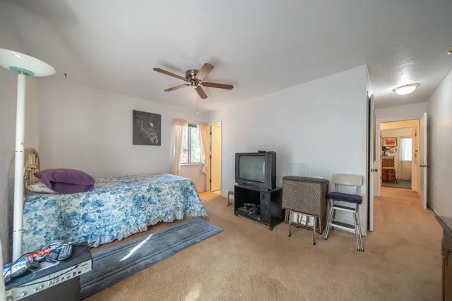 a bedroom with a bed a desk and chair