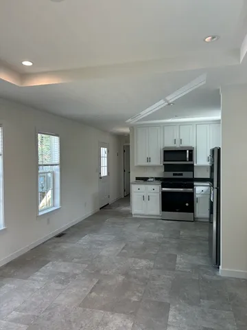 a view of kitchen with furniture and window