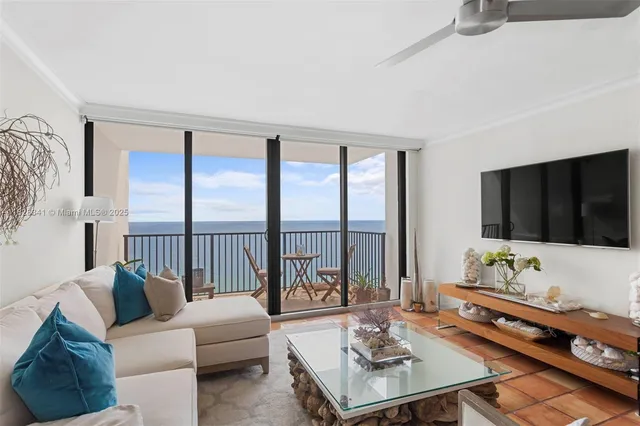 a living room with furniture and a floor to ceiling window