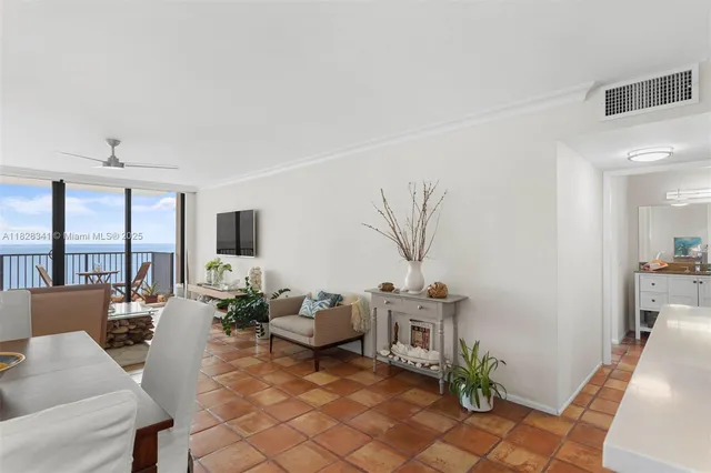 a living room with furniture a table and a potted plant