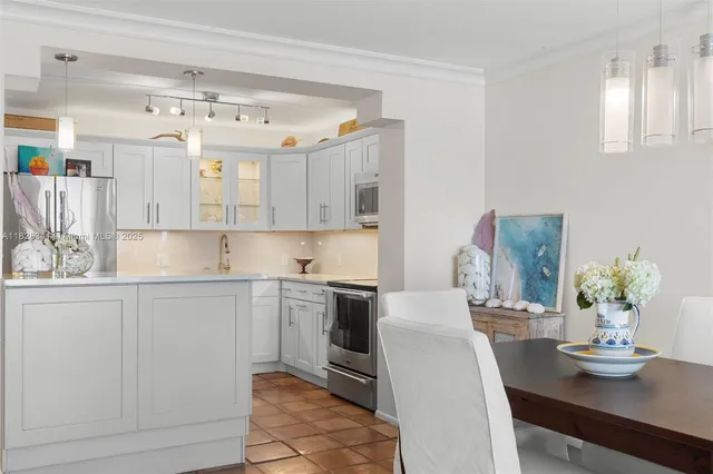 a kitchen with stainless steel appliances granite countertop a white cabinets and a stove