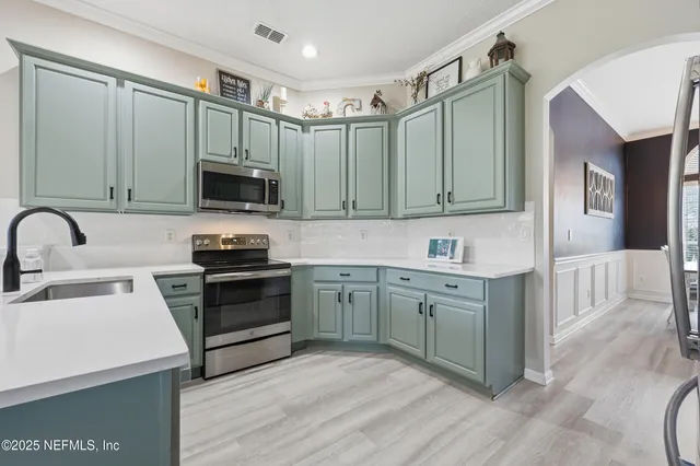 a kitchen with stainless steel appliances granite countertop a refrigerator and a sink