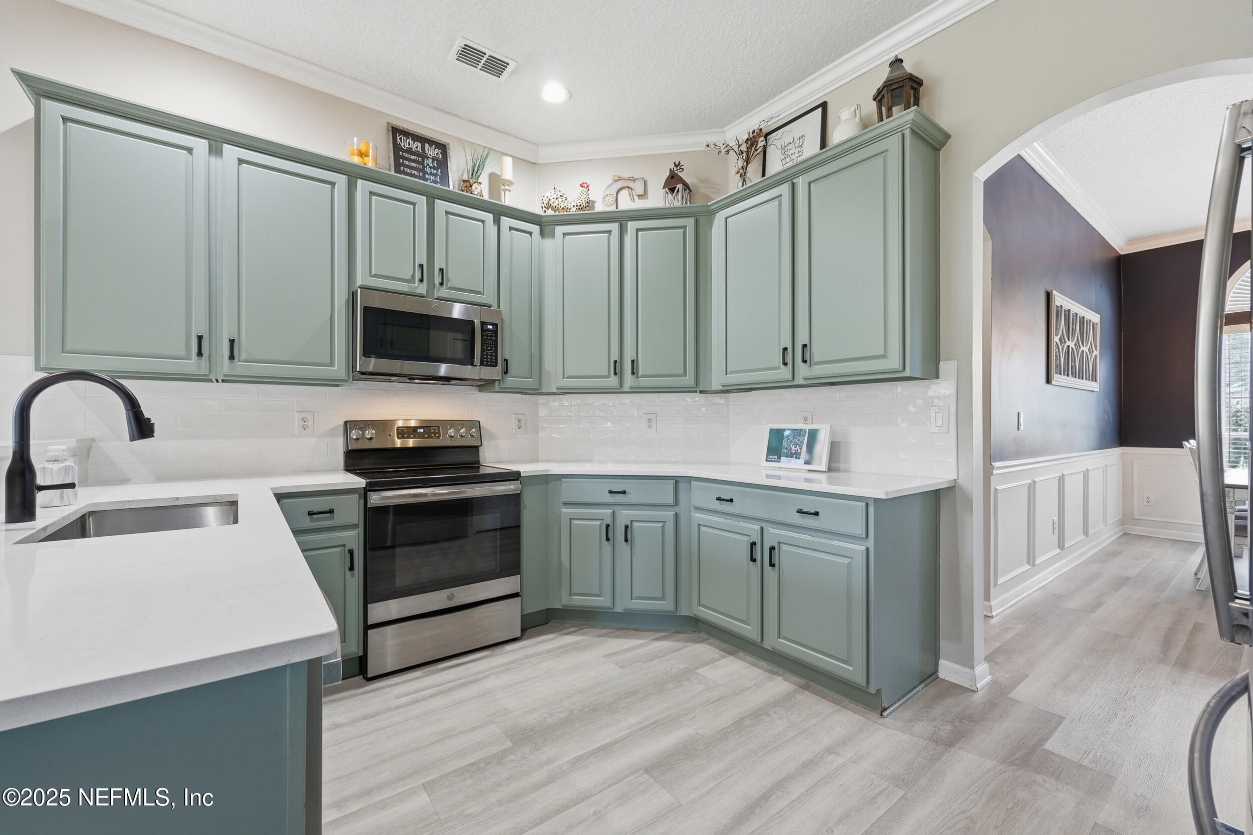 1605 Merroway Lane Ponte Vedra, FL 32081 - Photo 11 of 41 a kitchen with kitchen island granite countertop a sink cabinets and stainless steel appliances