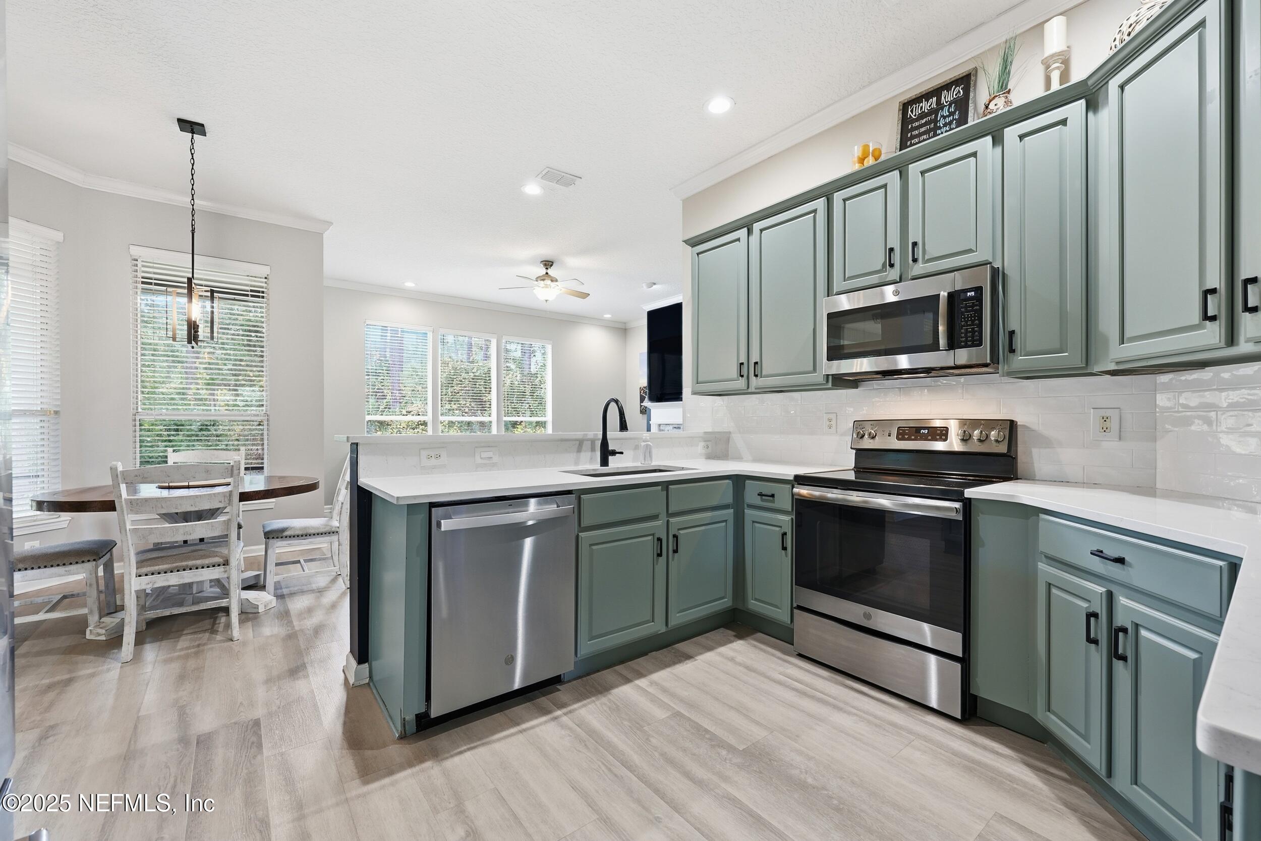 1605 Merroway Lane Ponte Vedra, FL 32081 - Photo 14 of 41 a kitchen with a sink stove and microwave