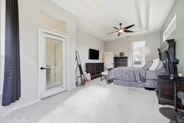 a bedroom with a bed and a flat tv screen