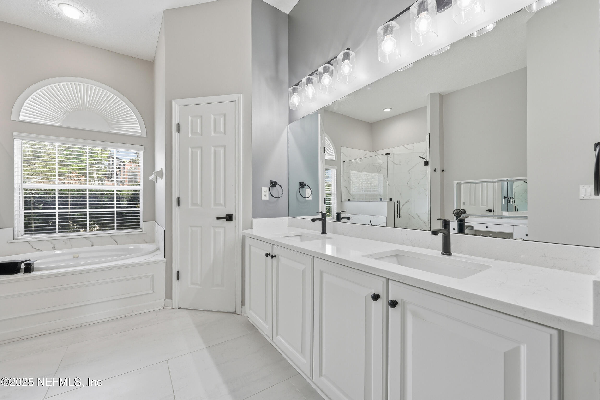 1605 Merroway Lane Ponte Vedra, FL 32081 - Photo 22 of 41 a spacious bathroom with a double vanity sink mirror and bathtub