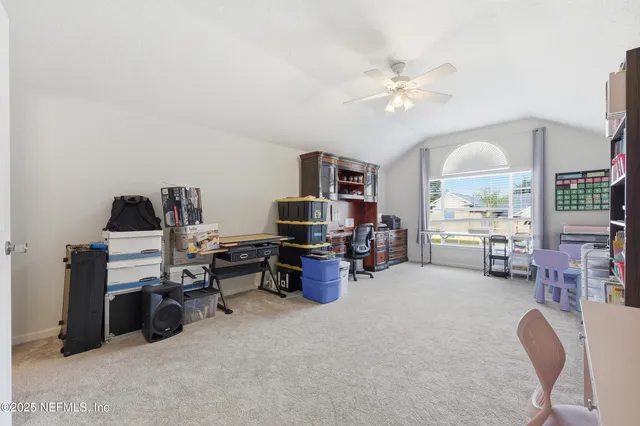 a room with furniture a chandelier and a flat screen tv