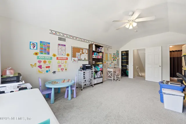 a bathroom with a sink a toilet a mirror and shower curtain