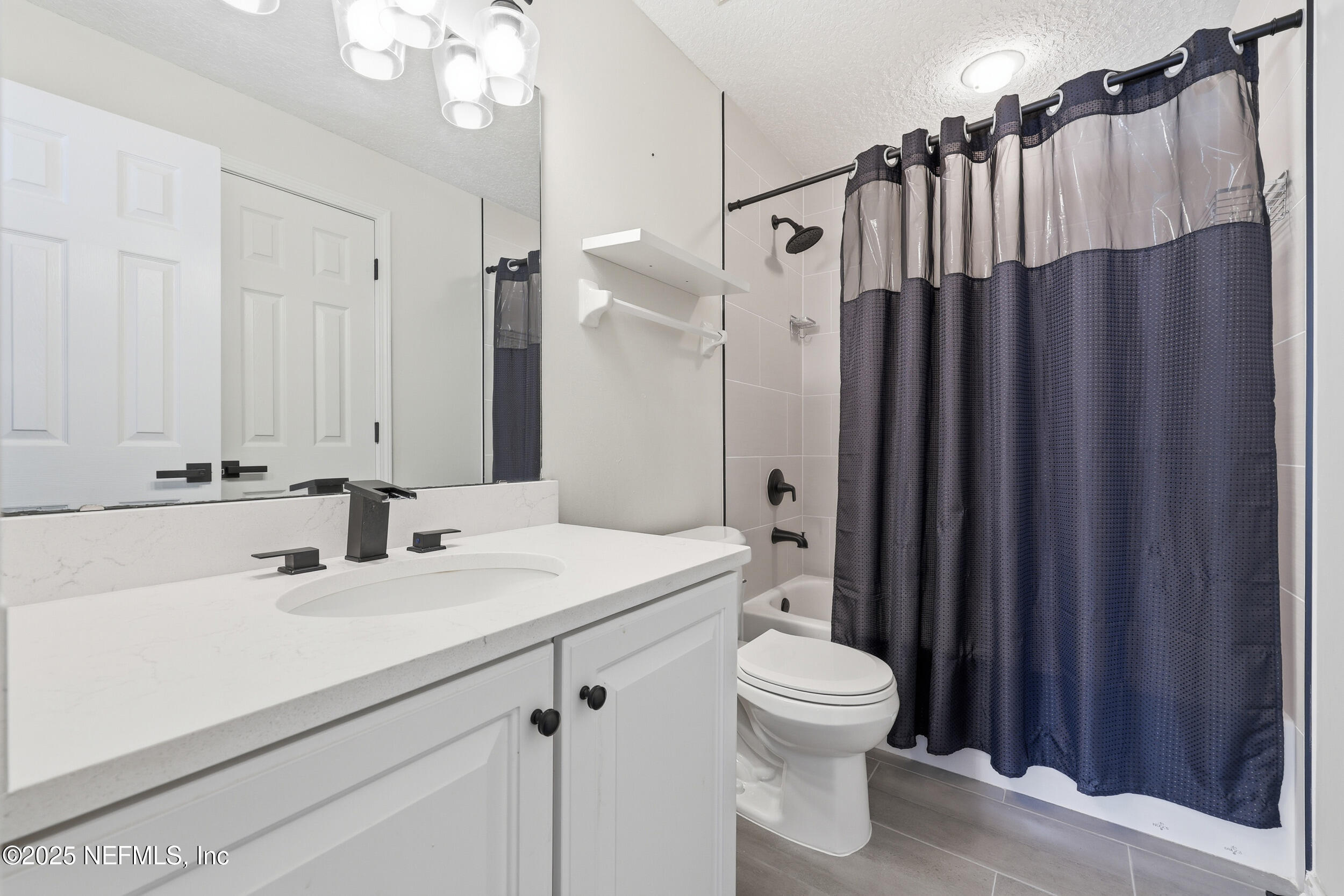 1605 Merroway Lane Ponte Vedra, FL 32081 - Photo 32 of 41 a bathroom with a sink a toilet a mirror and shower curtain