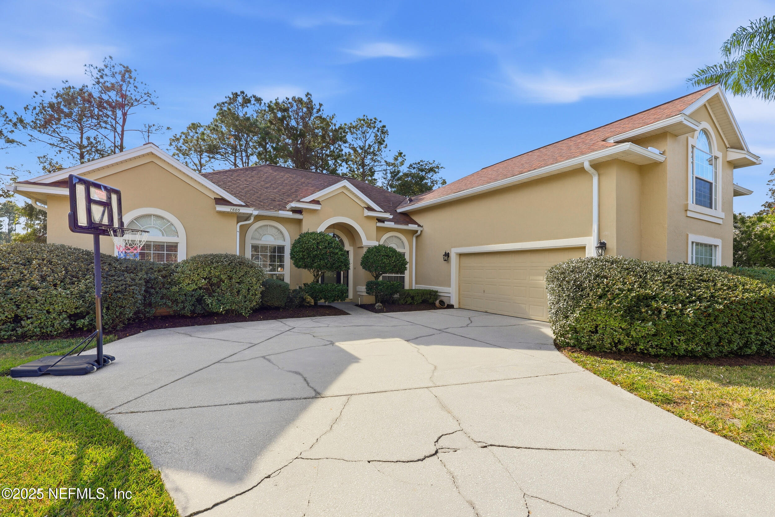 1605 Merroway Lane Ponte Vedra, FL 32081 - Photo 40 of 41 a view of a white house with a yard and potted plants