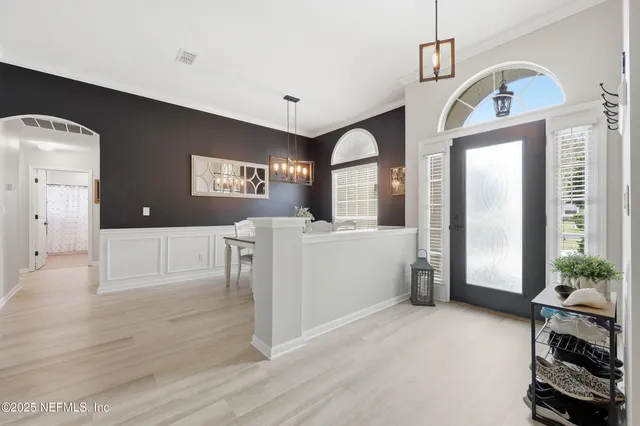 a living room with furniture and large windows