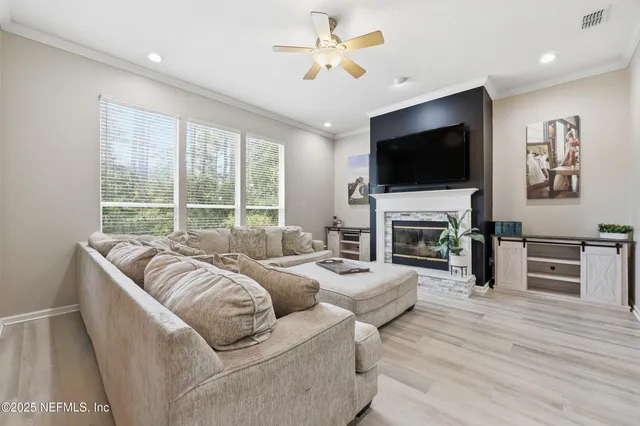a living room with furniture a fireplace and a flat screen tv