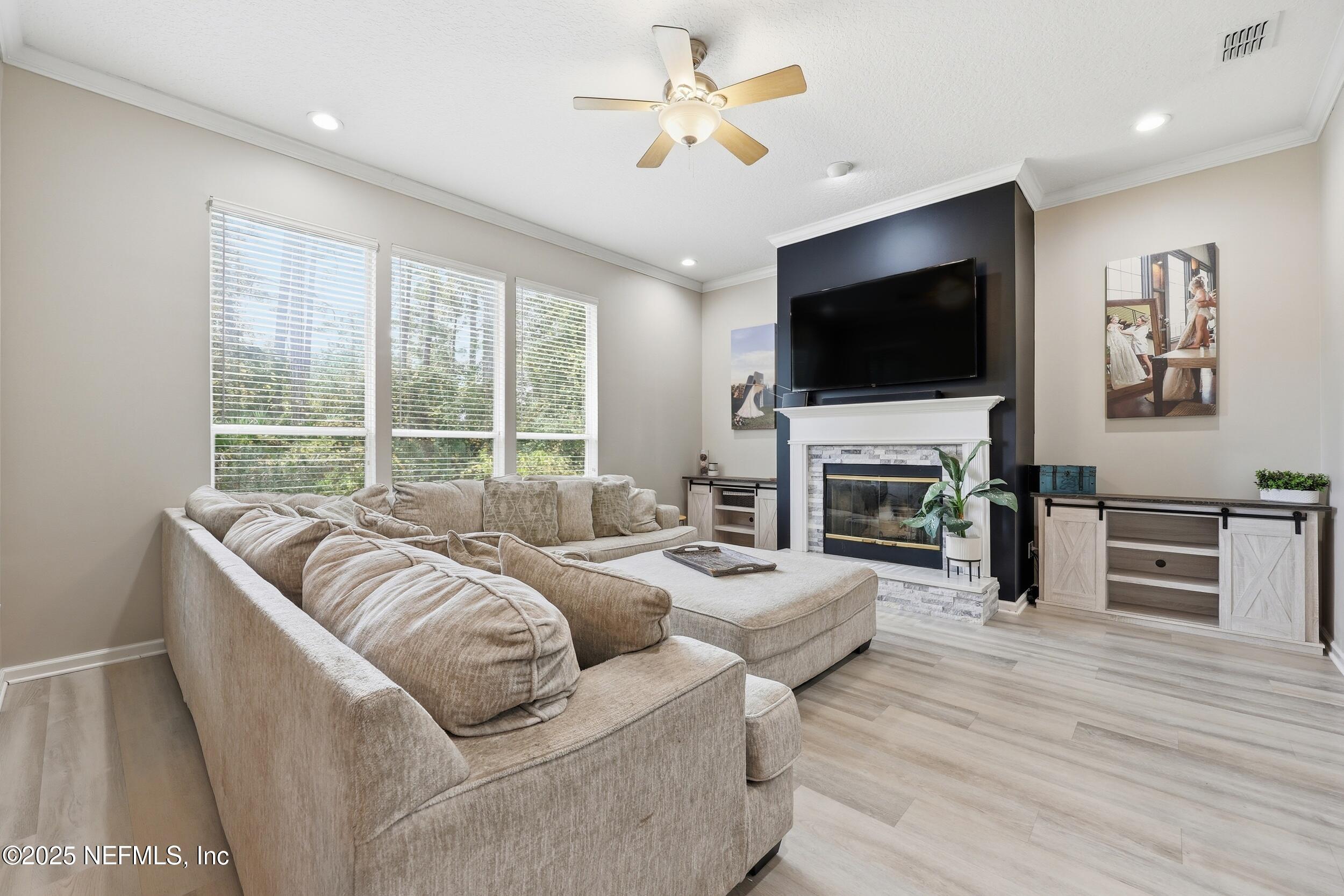 1605 Merroway Lane Ponte Vedra, FL 32081 - Photo 7 of 41 a living room with furniture a flat screen tv and a fireplace