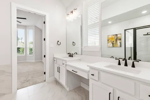 a bathroom with a double vanity sink mirror and double