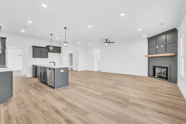 a large kitchen with stainless steel appliances kitchen island a large counter top and a wooden floors