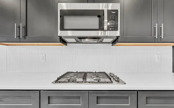 a stove sitting inside of a kitchen