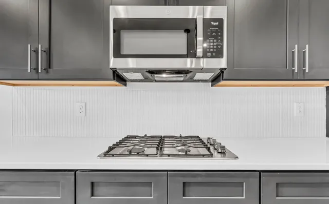 a stove sitting inside of a kitchen