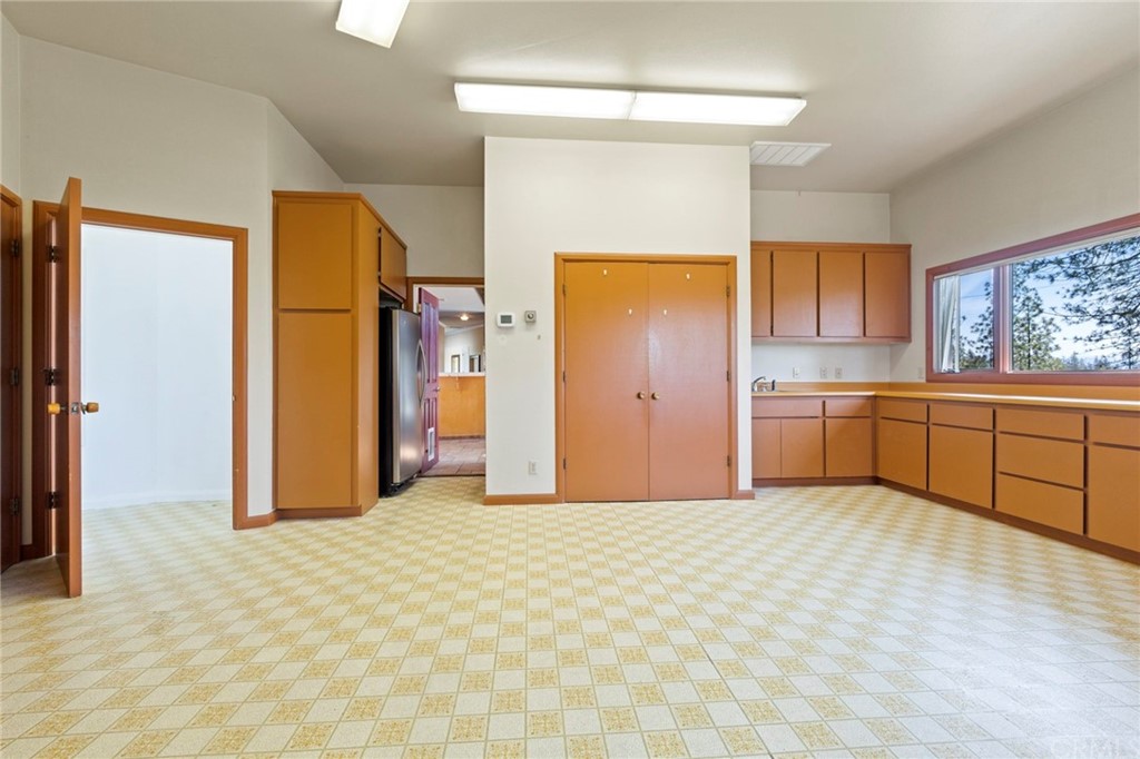 10379 McMahon Road Coulterville, CA 95311 - Photo 27 of 63 a view of a kitchen with a sink and a refrigerator