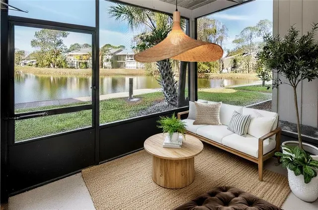 a view of a patio with couches table and chairs under an umbrella