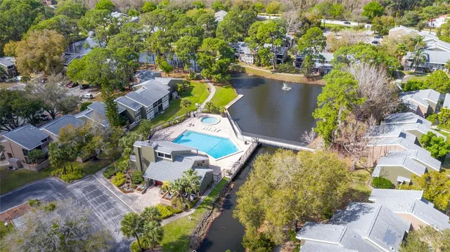 an aerial view of a house with a yard and lake view