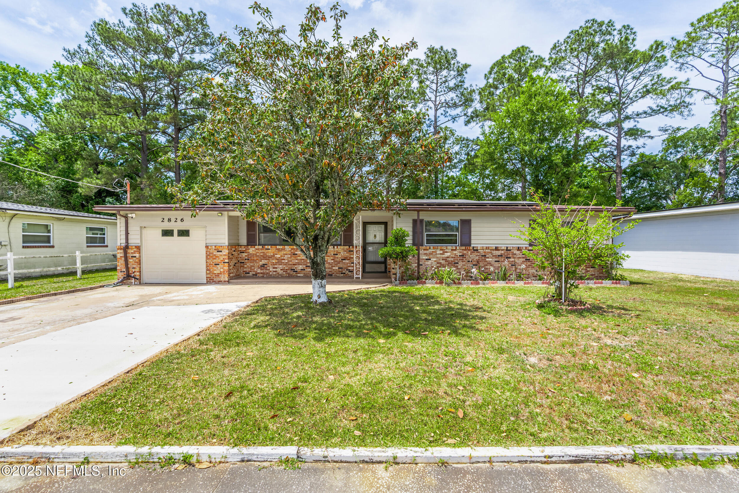 2826 Sam Road Jacksonville, FL 32216 - Photo 1 of 34 a front view of a house with garden