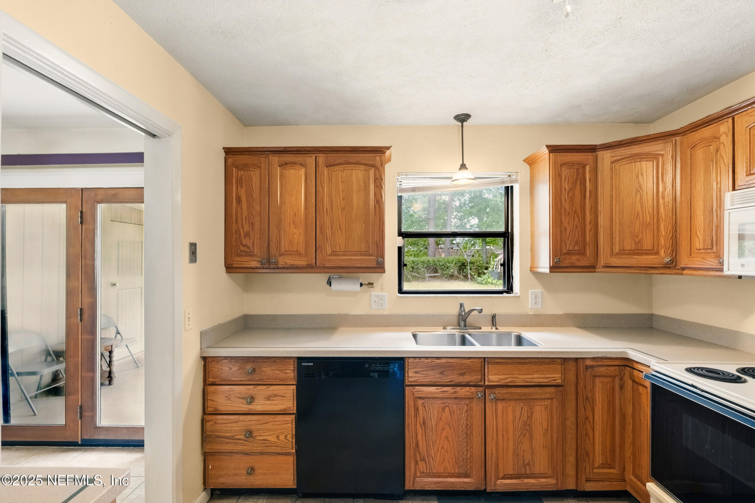 2826 Sam Road Jacksonville, FL 32216 - Photo 11 of 34 a kitchen with stainless steel appliances granite countertop a sink stove and cabinets