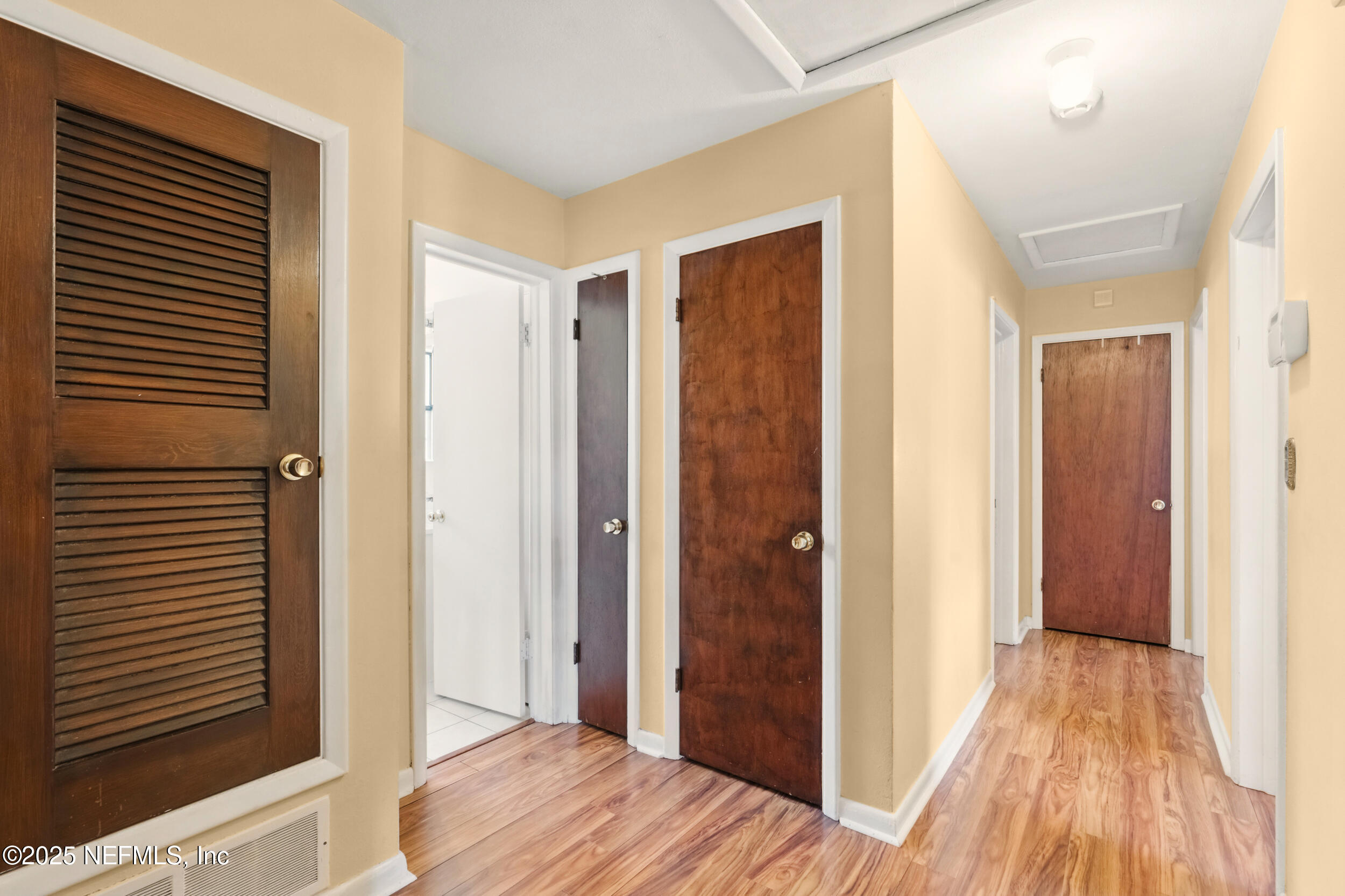 2826 Sam Road Jacksonville, FL 32216 - Photo 15 of 34 a view of a hallway with wooden floor and staircase