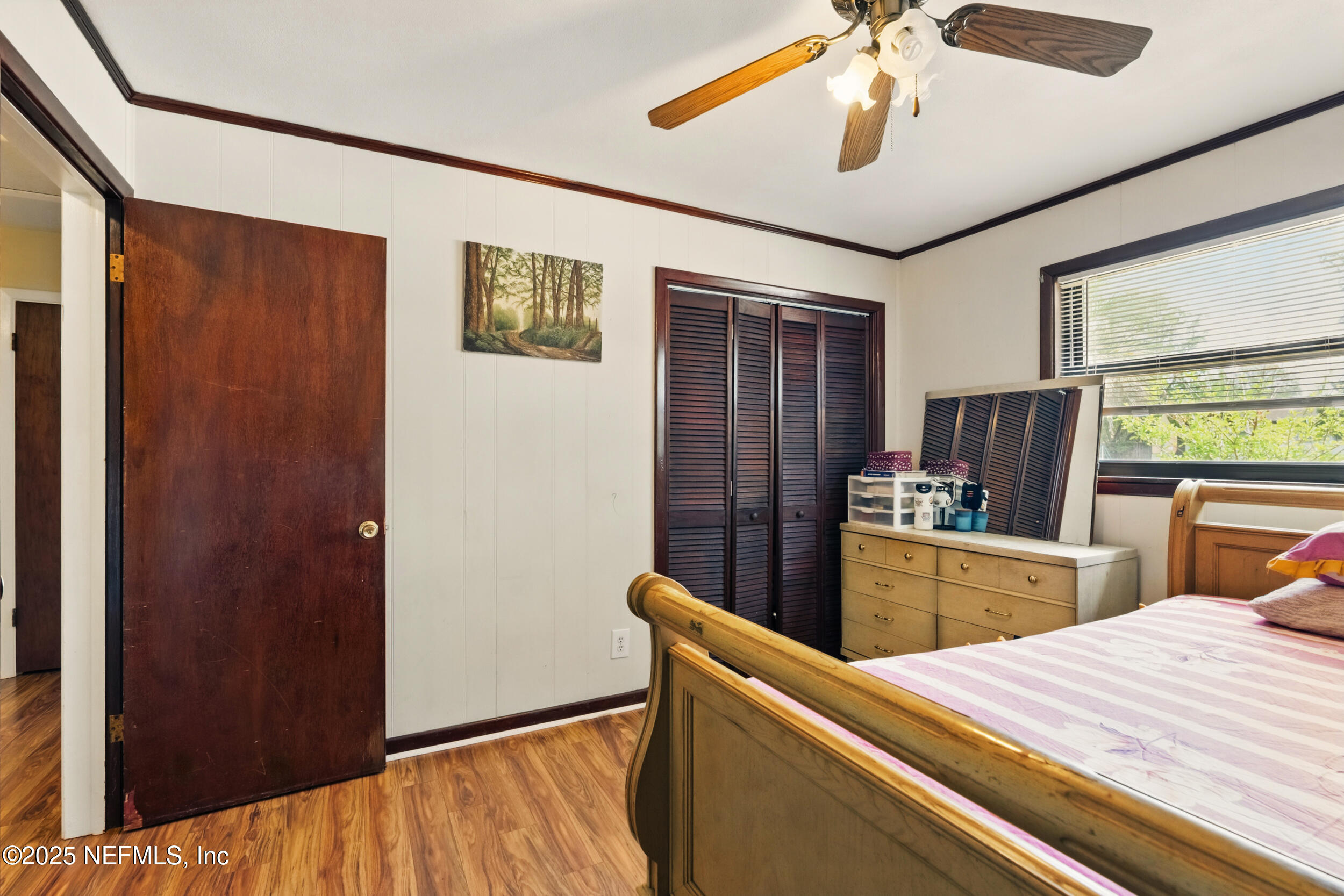 2826 Sam Road Jacksonville, FL 32216 - Photo 17 of 34 a room with wooden floor and window