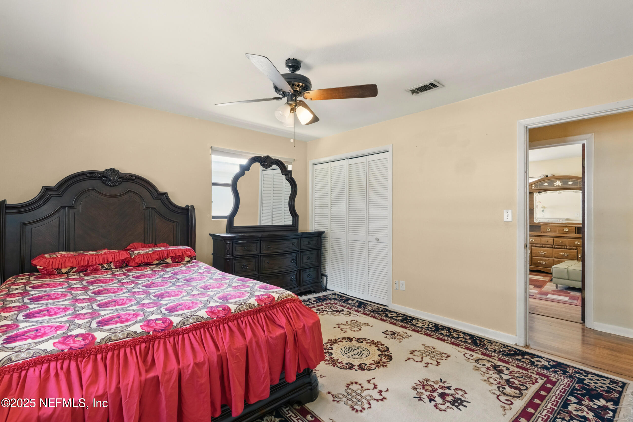 2826 Sam Road Jacksonville, FL 32216 - Photo 20 of 34 a bedroom with a bed and a dresser