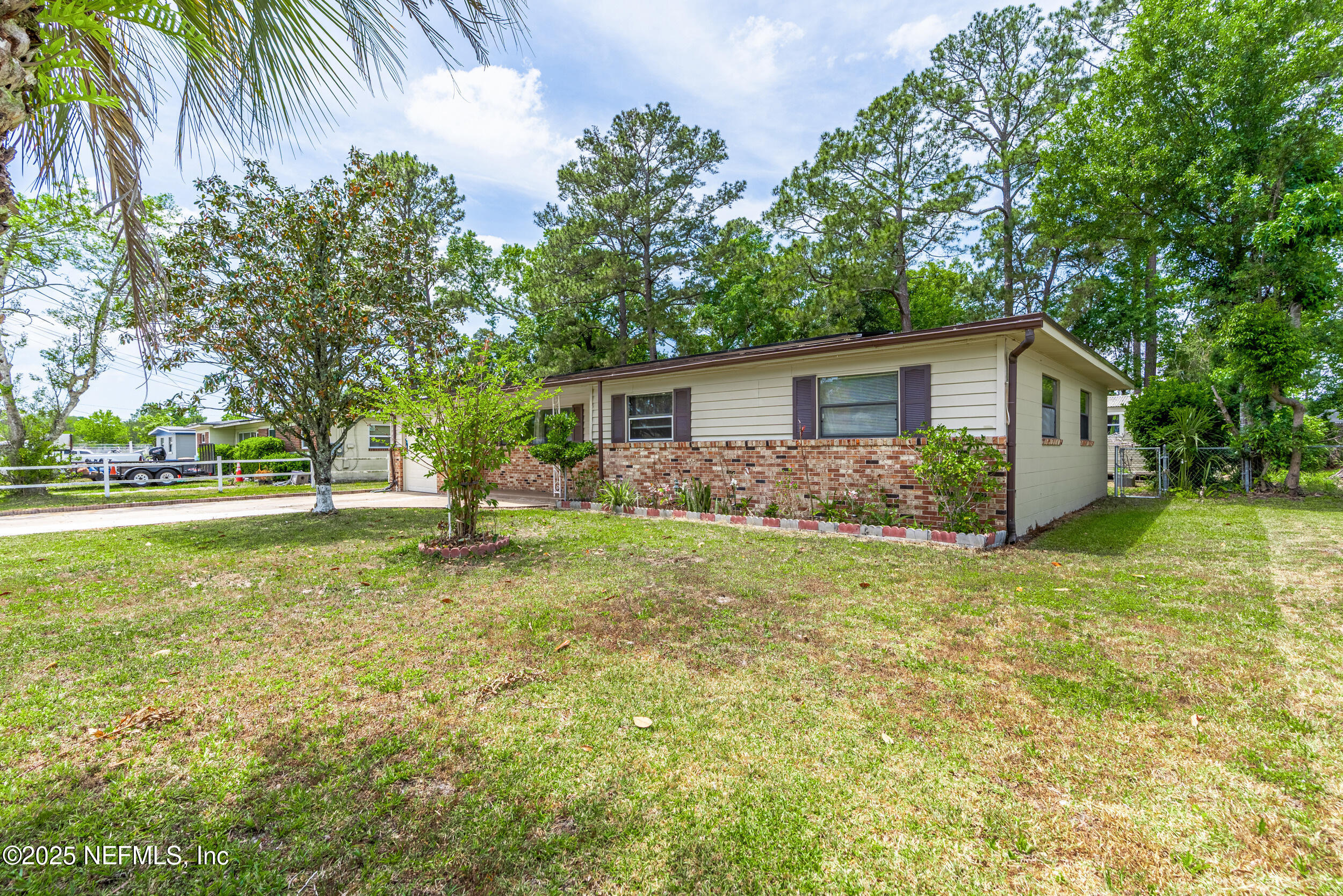 2826 Sam Road Jacksonville, FL 32216 - Photo 2 of 34 a view of a house with backyard and trees