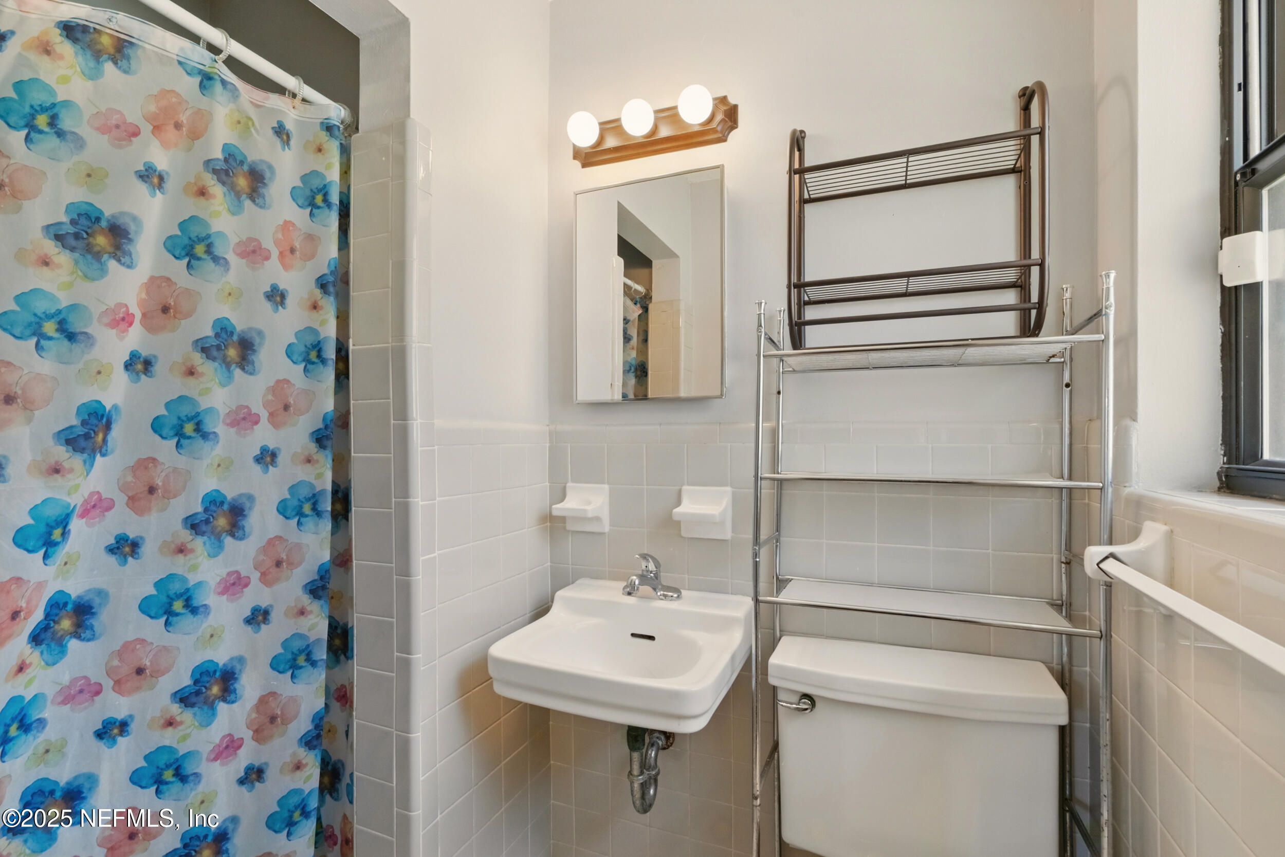 2826 Sam Road Jacksonville, FL 32216 - Photo 21 of 34 a bathroom with a sink toilet and mirror
