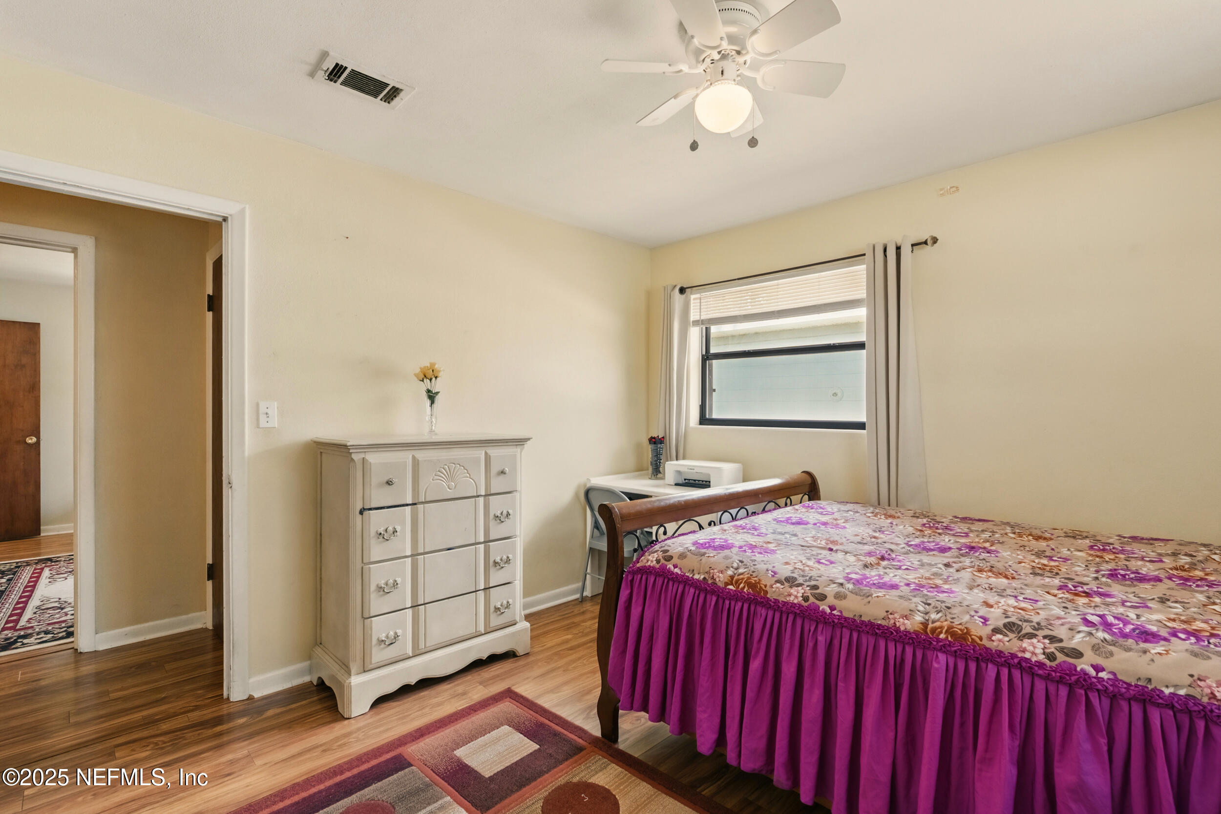 2826 Sam Road Jacksonville, FL 32216 - Photo 23 of 34 a bedroom with a bed and wooden floor