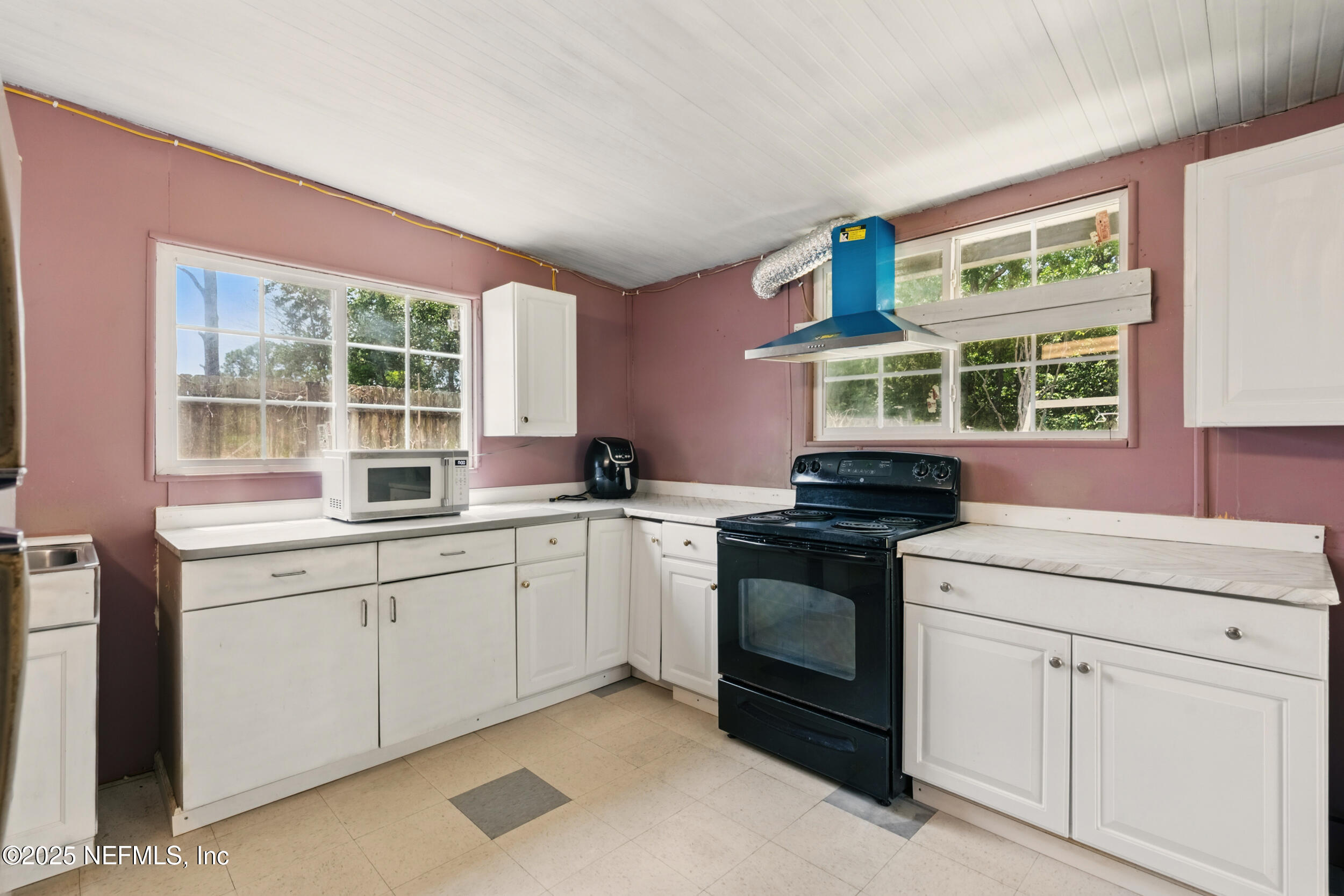 2826 Sam Road Jacksonville, FL 32216 - Photo 25 of 34 a kitchen with granite countertop a stove sink and window