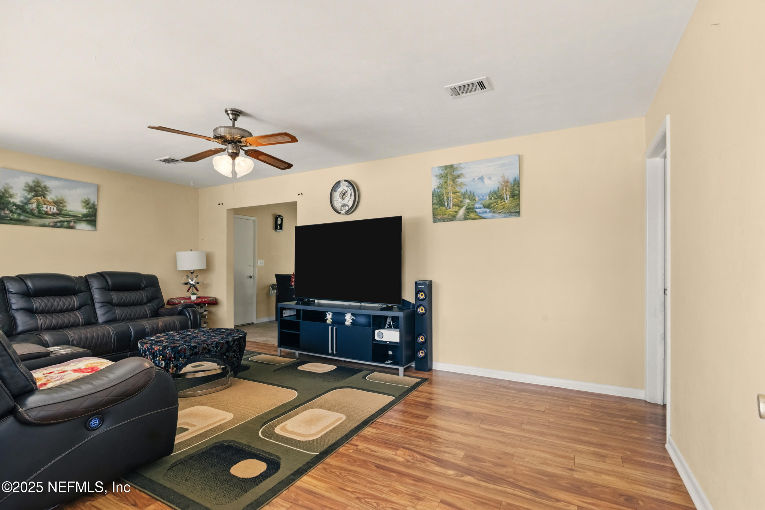 2826 Sam Road Jacksonville, FL 32216 - Photo 5 of 34 a living room with furniture and a flat screen tv
