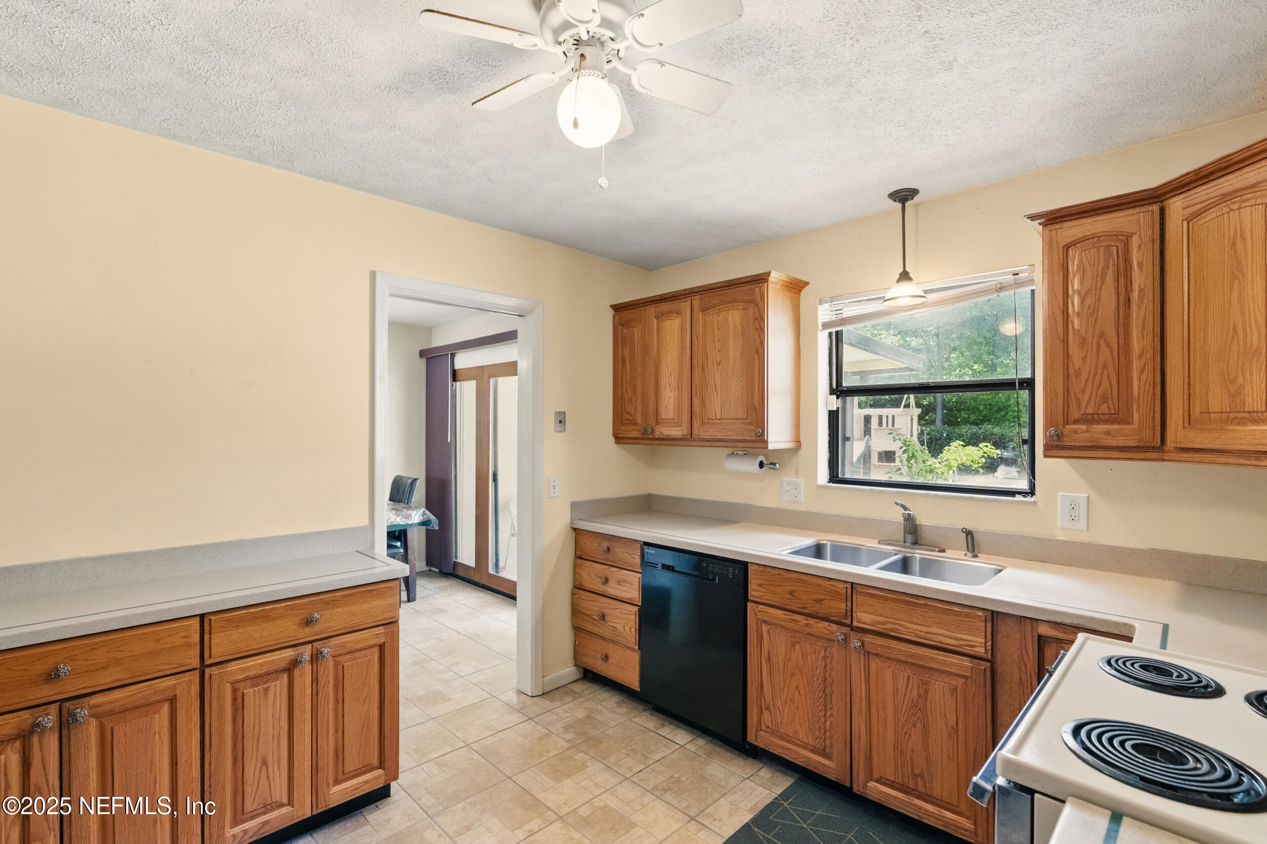 2826 Sam Road Jacksonville, FL 32216 - Photo 10 of 34 a kitchen with stainless steel appliances granite countertop a sink cabinets and wooden floor