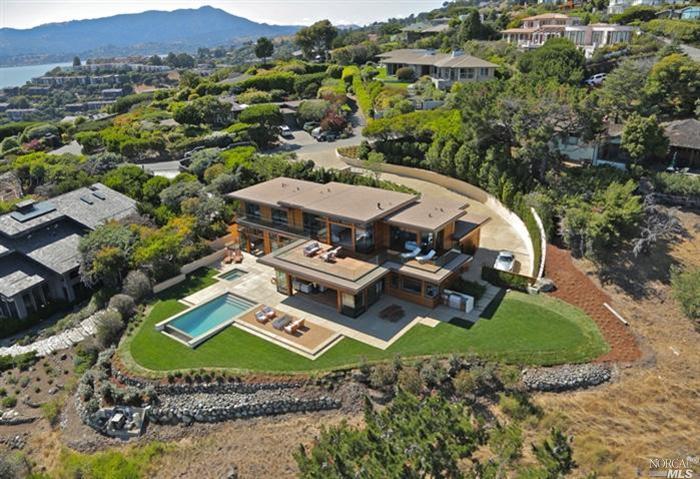 an aerial view of a house with garden space and street view