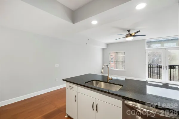a kitchen with kitchen island a counter top space a sink and appliances