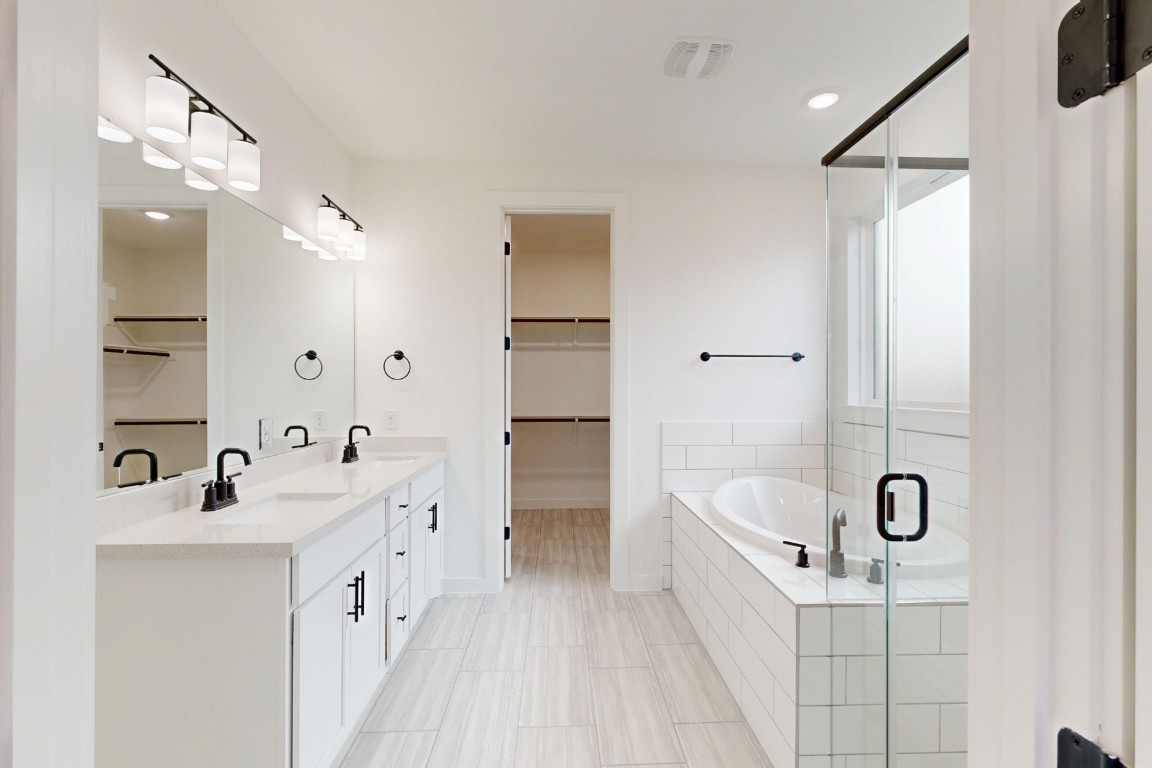 2020 Billings Way Leander, TX 78641 - Photo 13 of 35 a bathroom with a tub sink and mirror