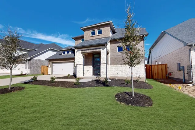 a front view of a house with a yard