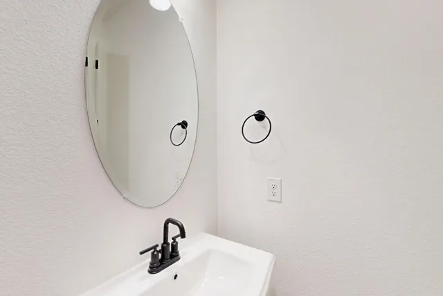 a view of cabinets and utility room with wooden floor