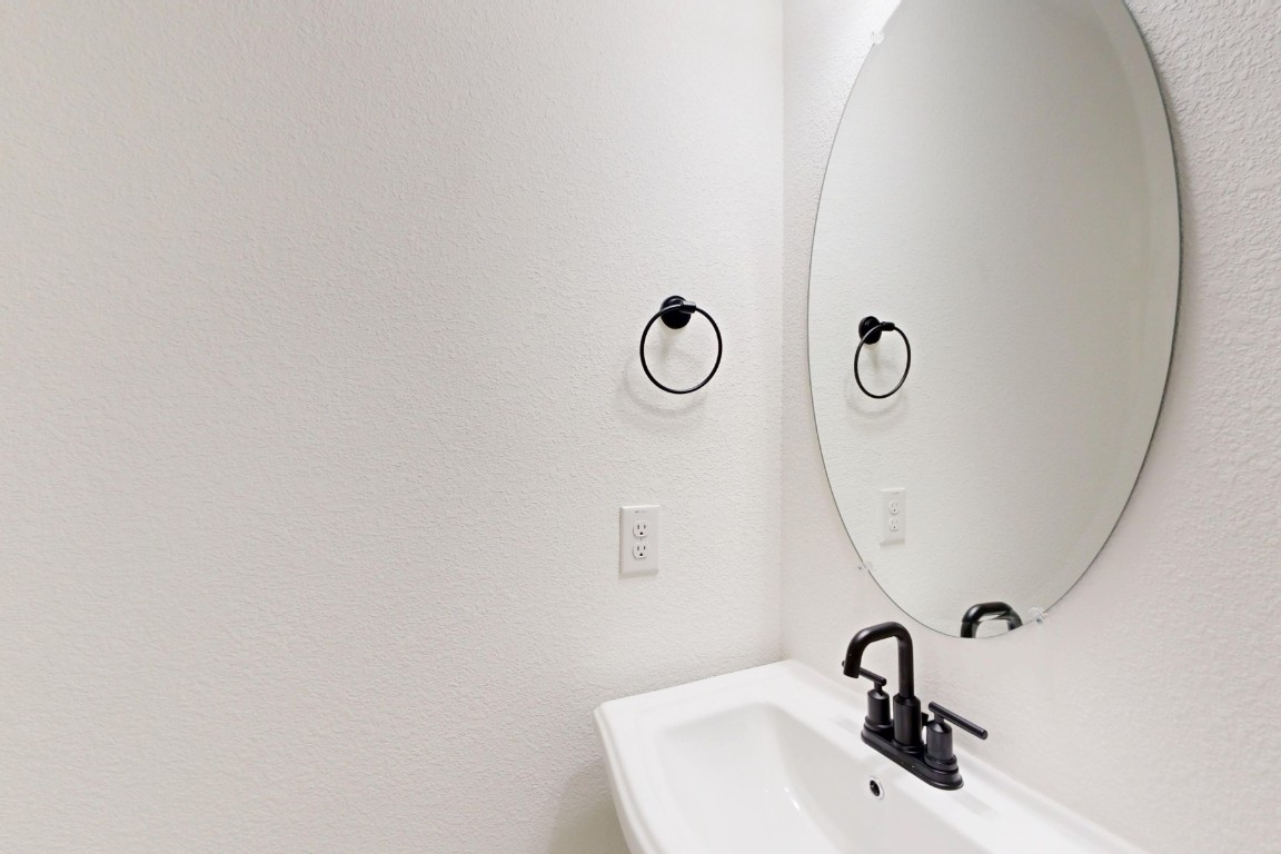 2020 Billings Way Leander, TX 78641 - Photo 29 of 35 a bathroom with a sink and mirror