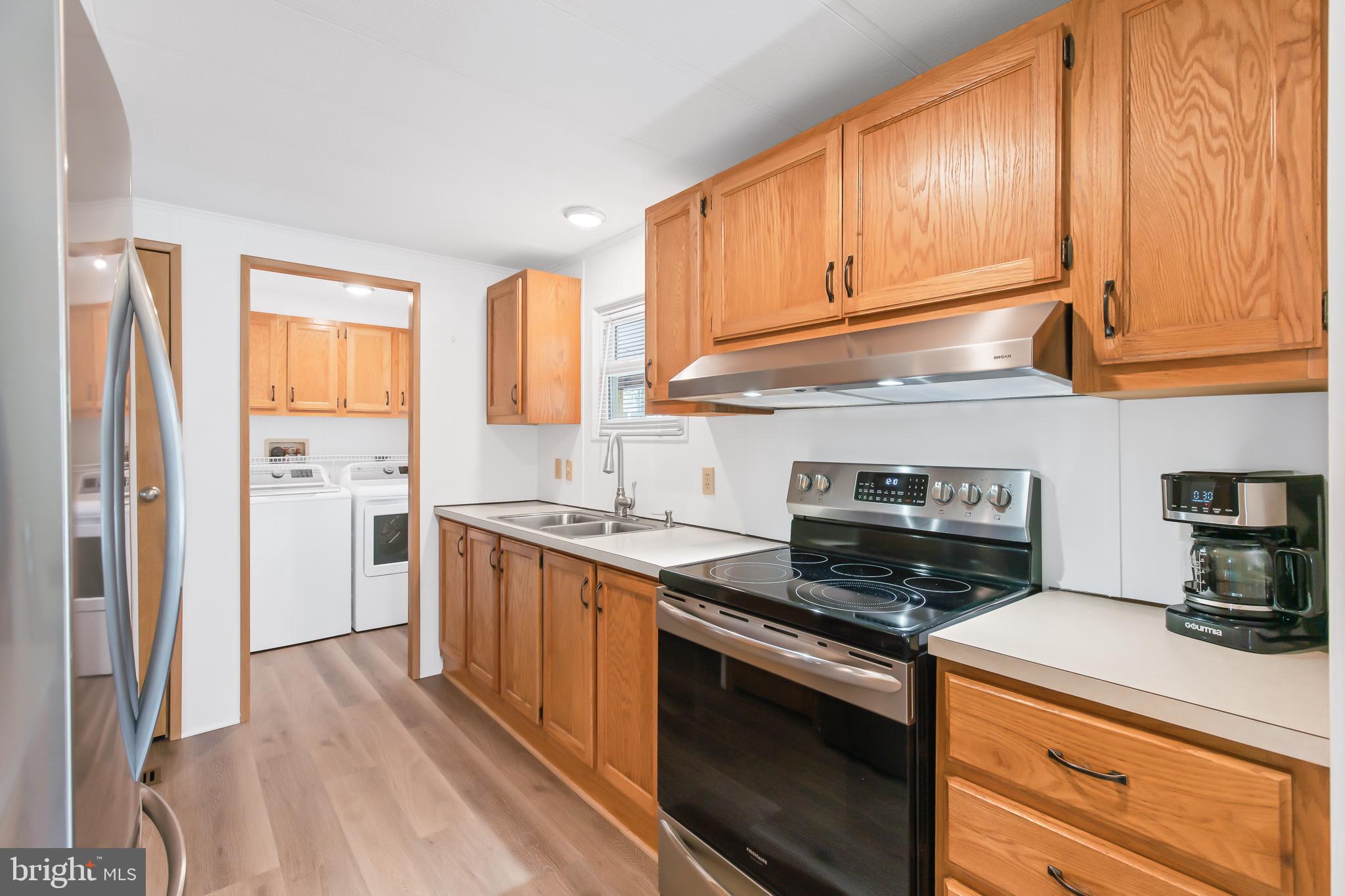 411 Maple Avenue Manheim, PA 17545 - Photo 12 of 35 a kitchen with stainless steel appliances granite countertop a stove a sink and a refrigerator
