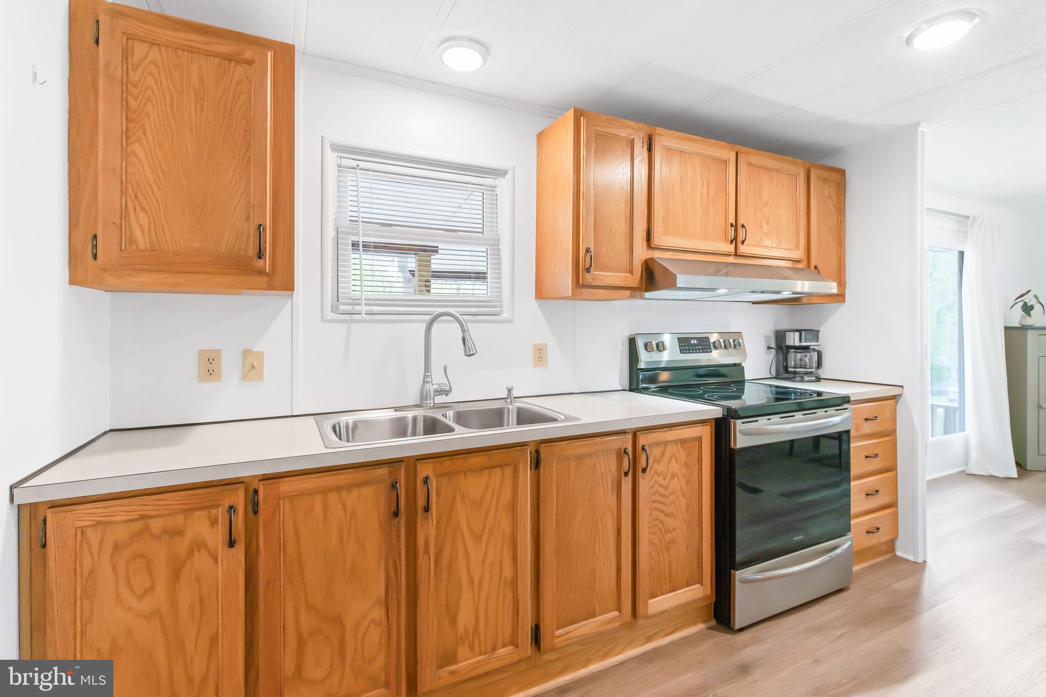 411 Maple Avenue Manheim, PA 17545 - Photo 14 of 35 a kitchen with stainless steel appliances granite countertop a sink stove and cabinets