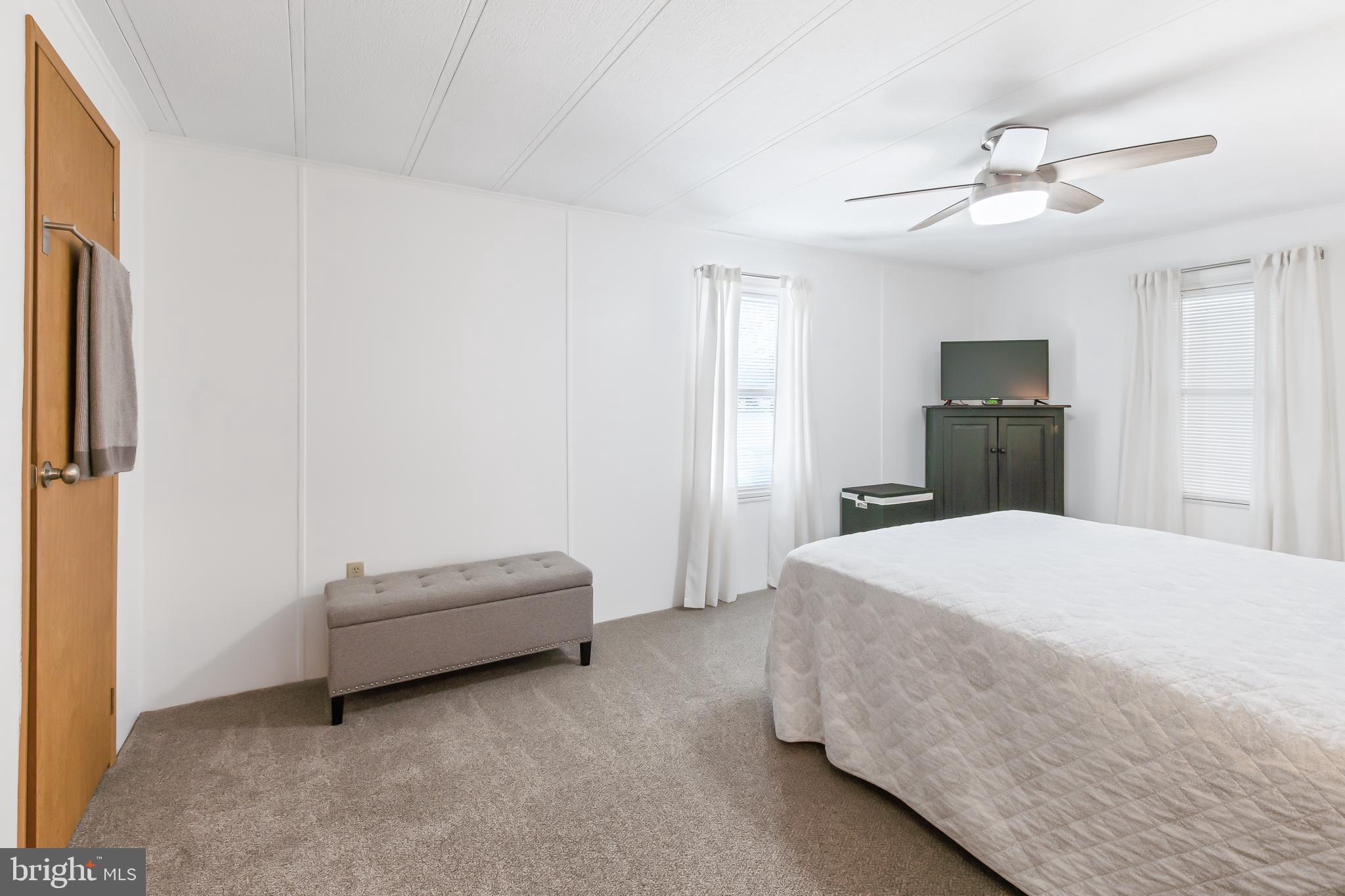 411 Maple Avenue Manheim, PA 17545 - Photo 19 of 35 a spacious bedroom with a bed and a chandelier