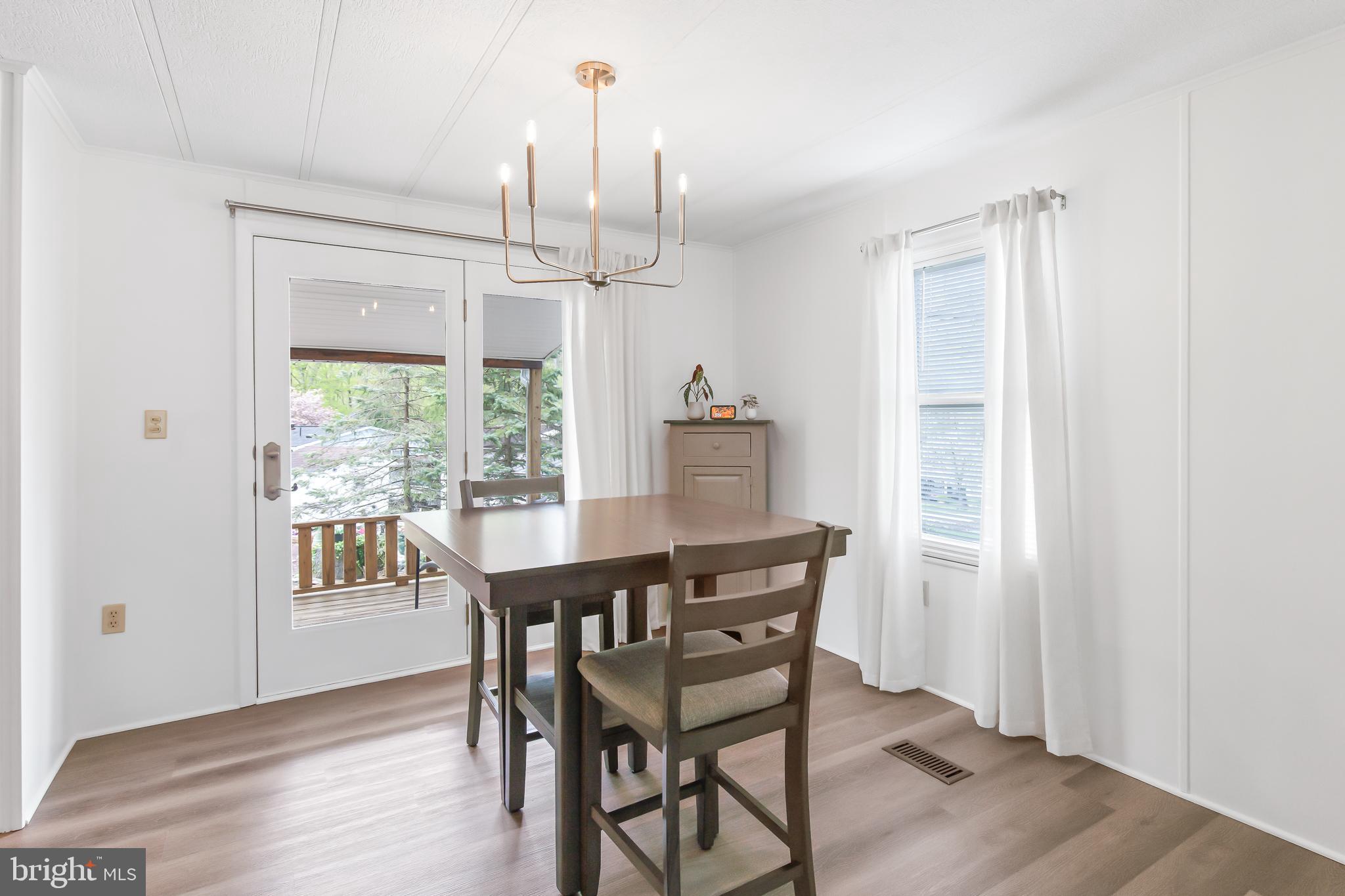 411 Maple Avenue Manheim, PA 17545 - Photo 9 of 35 a view of a dining room with furniture window and wooden floor