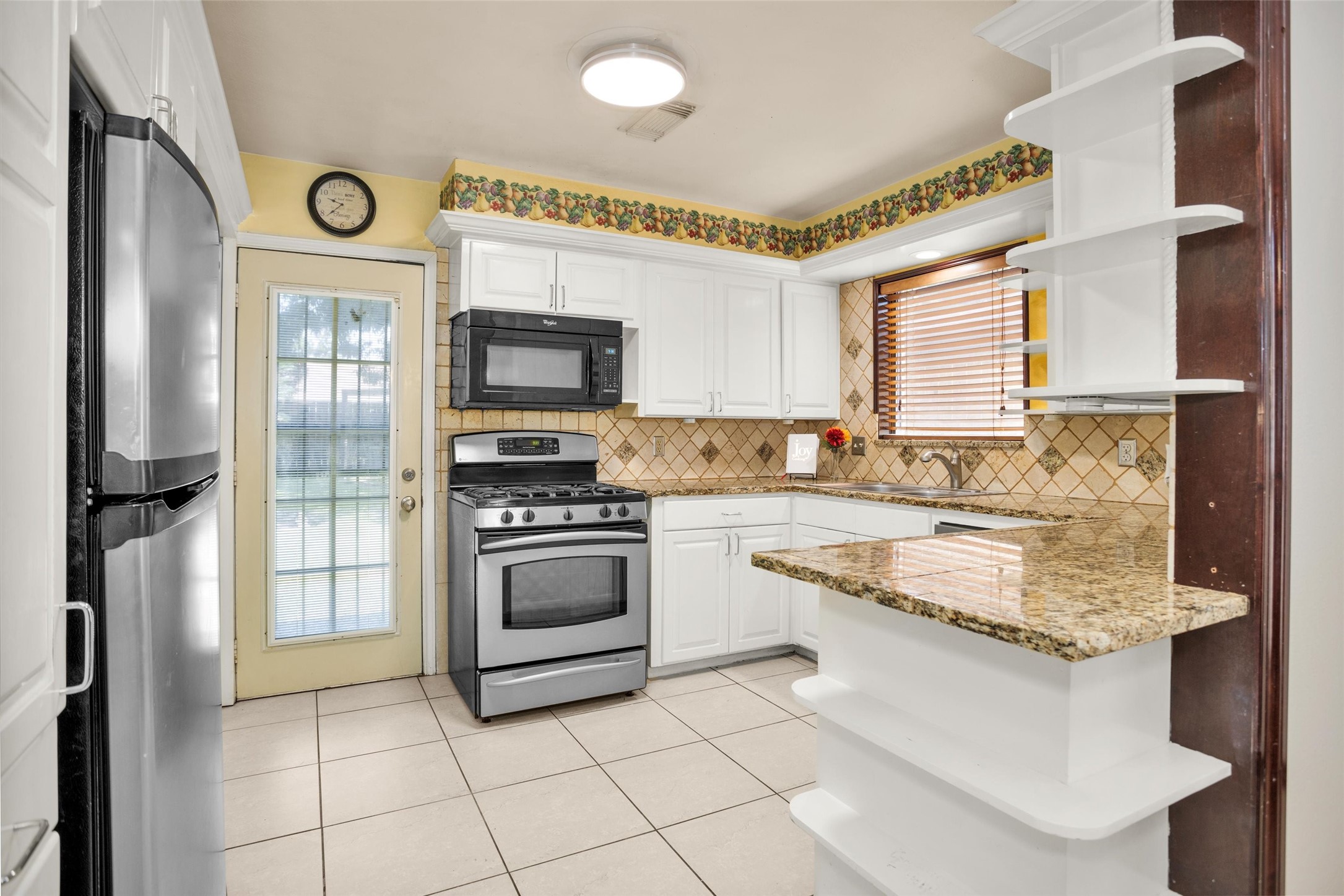 1102 Mosher Lane Houston, TX 77088 - Photo 14 of 50 a kitchen with stainless steel appliances granite countertop a stove a sink and a refrigerator