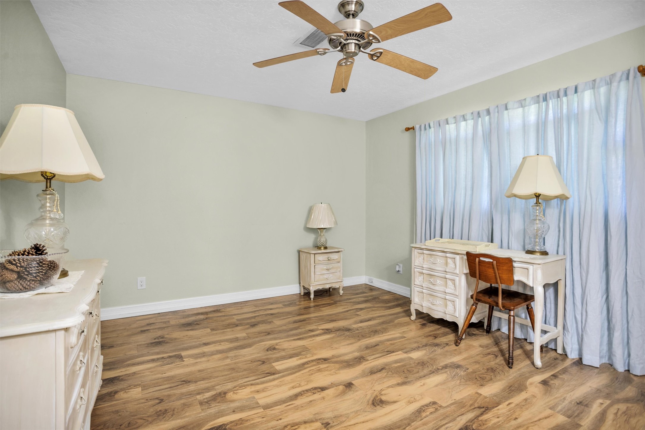1102 Mosher Lane Houston, TX 77088 - Photo 18 of 50 a bedroom with a bed and a chandelier
