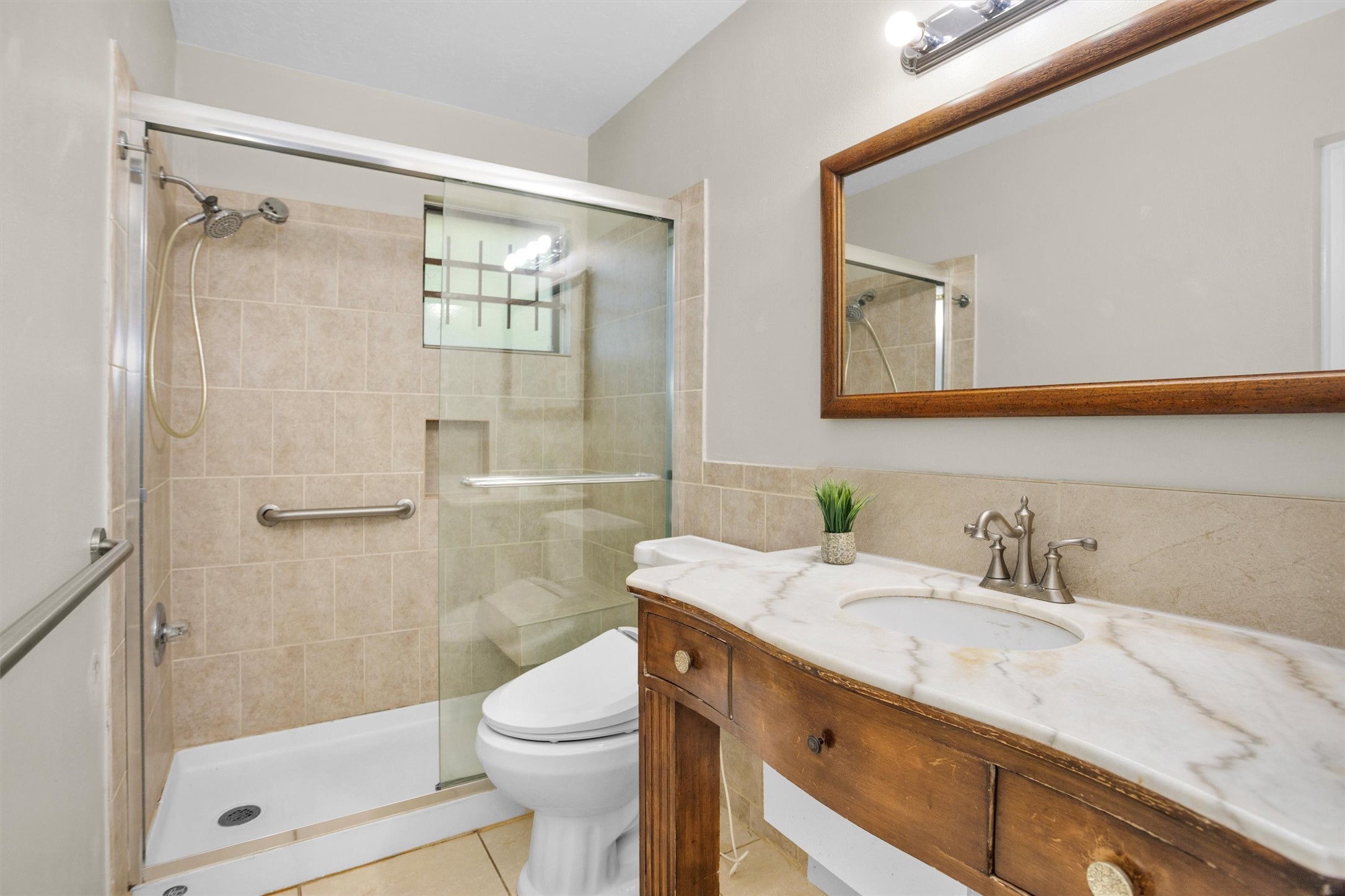 1102 Mosher Lane Houston, TX 77088 - Photo 20 of 50 a bathroom with a sink a toilet and shower